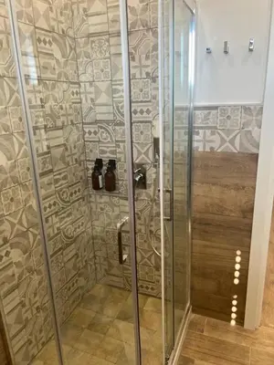 a shower with a glass door in a bathroom at Scilia casa vacanza in Palermo