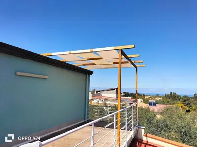 a balcony with awning on top of a building at Ciuri CiuriHome in Balestrate
