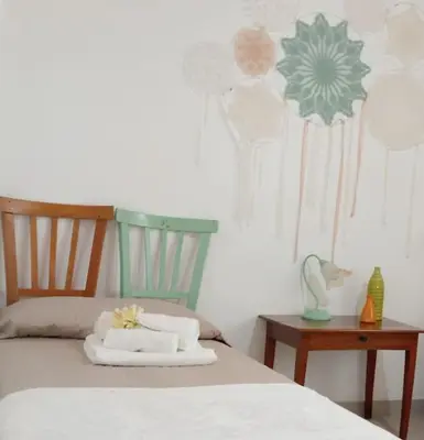 a bedroom with a bed and a nightstand with a table at Ciuri CiuriHome in Balestrate