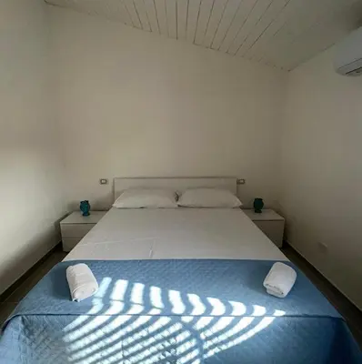 a bedroom with a bed with two pillows on it at La Maiolica 59 in Terrasini