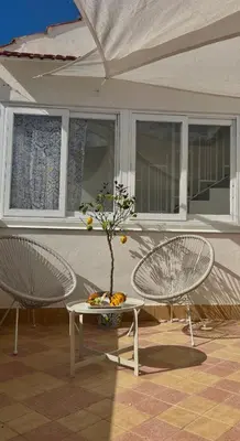 two chairs and a table with a tree on it at La Maiolica 59 in Terrasini