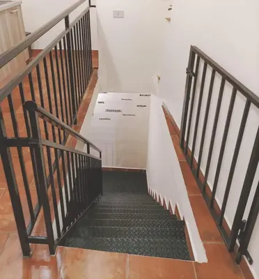 a staircase with a large box in a room at La casa del cocchiere in Palermo