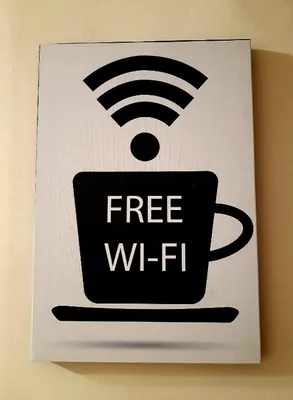 a free wifi sign on a wall with a coffee cup at La casa del cocchiere in Palermo