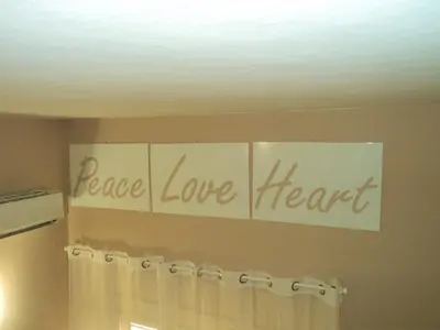 a sign that says peace love love heart on a wall at Virna House a Castellammare del Golfo in Castellammare del Golfo