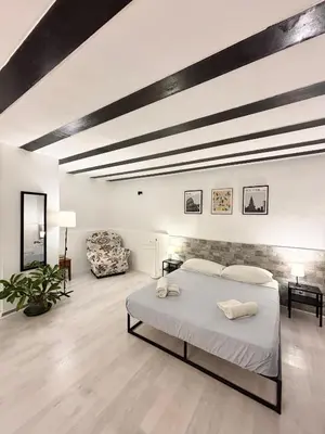 a bedroom with a large bed in a room at Casa Pipa in Palermo