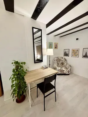a room with a desk with a chair and a couch at Casa Pipa in Palermo