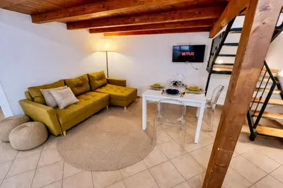 a patio with two chairs and a table and a large tub at Casa Meravigghia terrazzo ,giardino e Jacuzzi in Palermo