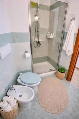 a kitchen with wooden cabinets and a white refrigerator at Casa Meravigghia terrazzo ,giardino e Jacuzzi in Palermo