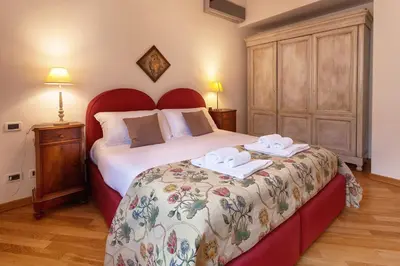 a bedroom with a bed with two towels on it at Palazzo Mazzarino in Palermo
