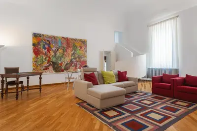 a living room with a couch and a painting on the wall at Palazzo Mazzarino in Palermo