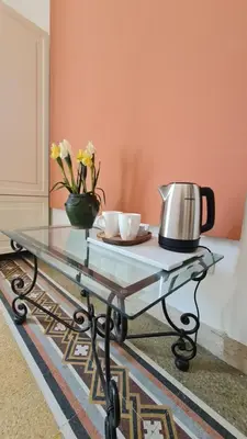 a glass table with two cups and a tea pot on it at MaisonNouveau in Palermo
