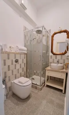 a bathroom with a shower and a toilet and a sink at MaisonNouveau in Palermo
