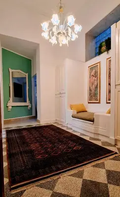 a living room with a couch and a chandelier at MaisonNouveau in Palermo