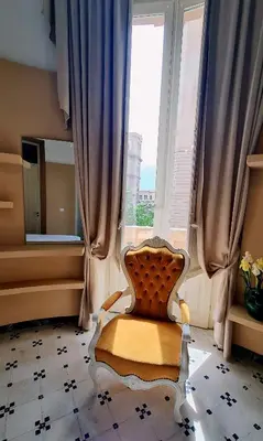 a chair in a room with a large window at MaisonNouveau in Palermo