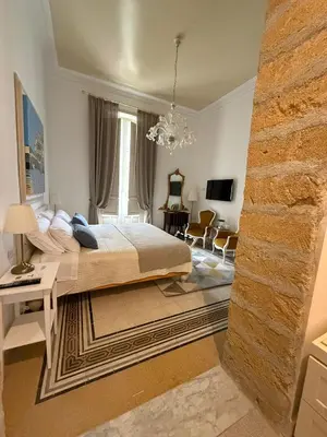 a bedroom with a bed and a brick wall at MaisonNouveau in Palermo