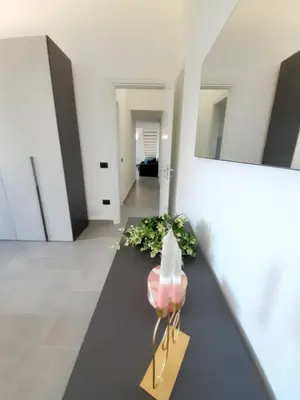 a living room with a table and some plants at Campofelice Holidays West Villa in Campofelice di Roccella