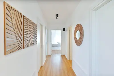 a hallway with white walls and wooden floors at Stefy's Home #Cattedrale in Palermo