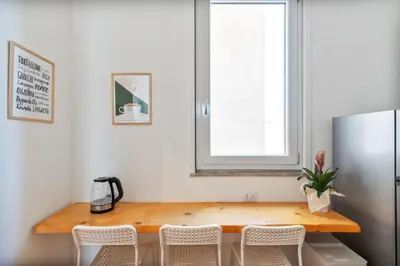 a kitchen with a table and chairs and a refrigerator at Stefy's Home #Cattedrale in Palermo