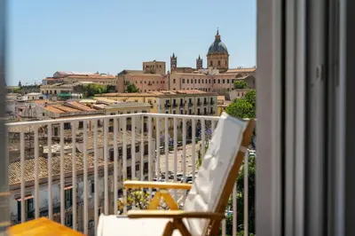 a balcony with a chair and a view of a city at Stefy's Home #Cattedrale in Palermo