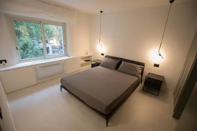 a bedroom with a bed and a window and lights at G&M Place in Palermo