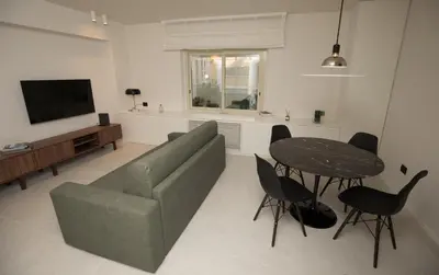 a living room with a couch and a table at G&M Place in Palermo