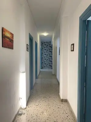 a hallway with blue doors and a tile floor at Casa Visconti 170mq-centro storico in Palermo