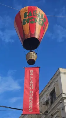 a hot air balloon flying over a sign with a banner at Dietro Ballarò - Guest House in Palermo