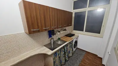 a kitchen with a sink and a washing machine at Dietro Ballarò - Guest House in Palermo