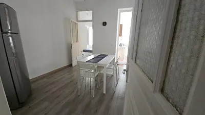 a dining room with a white table and chairs at Dietro Ballarò - Guest House in Palermo
