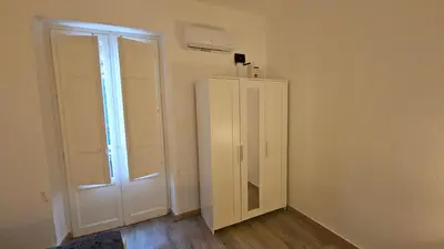 an empty room with a closet and a door at Dietro Ballarò - Guest House in Palermo