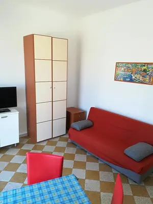 a living room with a red couch and red chairs at Appartamento Mediterraneo Mondello in Palermo