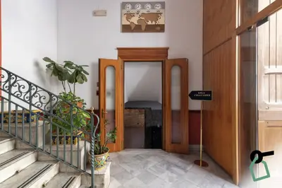 a hallway with a door with a potted plant at HOTIDAY Room Collection - Palermo Politeama in Palermo