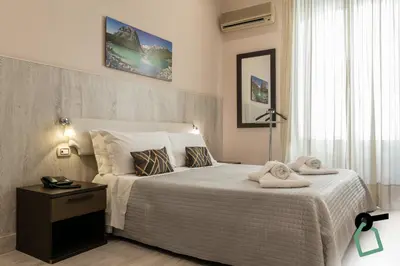 a bedroom with a bed with towels on it at HOTIDAY Room Collection - Palermo Politeama in Palermo