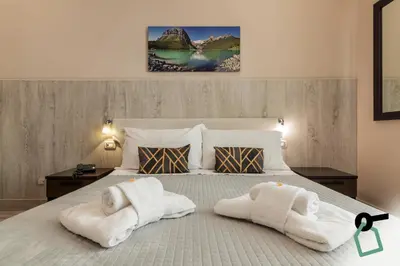 a bedroom with a bed with towels on it at HOTIDAY Room Collection - Palermo Politeama in Palermo