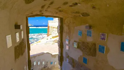an archway in a building with a view of the ocean at ViLoKa Sicilian Guest House in Calatafimi