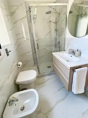 a bathroom with a toilet sink and a shower at ViLoKa Sicilian Guest House in Calatafimi