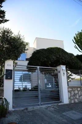 a gate in front of a house with a fence at Villa Luxury Fronte mare San Vito lo Capo in San Vito lo Capo