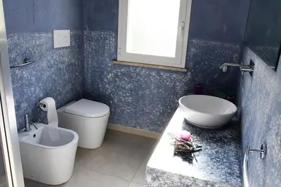 a bathroom with a sink and a toilet and a tub at Villa Luxury Fronte mare San Vito lo Capo in San Vito lo Capo