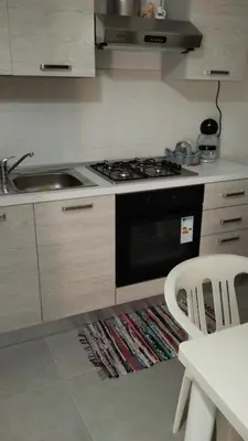 a kitchen with a stove and a sink at Casa Gerani in Castellammare del Golfo