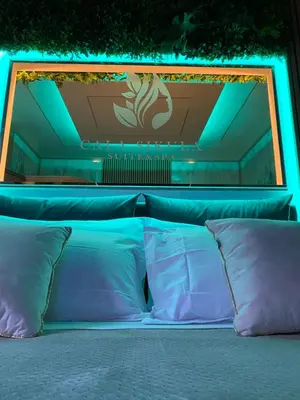 a bed with a blue light on top of it at Cala Sikula Suite &SPA in Palermo