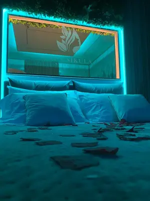 a bedroom with a bed with a blue light at Cala Sikula Suite &SPA in Palermo