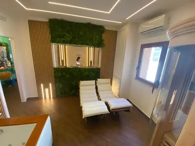 a room with a row of white chairs and a mirror at Cala Sikula Suite &SPA in Palermo