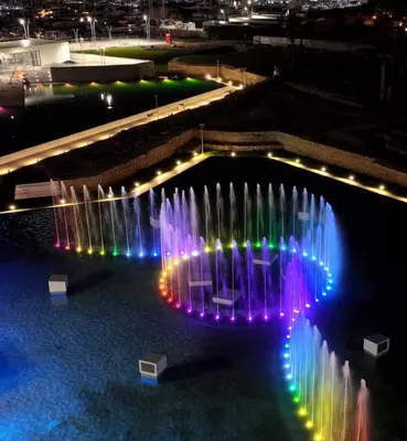 a fountain with lights in the water at night at Cala Sikula Suite &SPA in Palermo