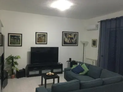 a living room with a couch and a flat screen tv at Elegante Appartamento Palermo in Palermo