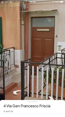 a building with a wooden door and some stairs at Elegante Appartamento Palermo in Palermo