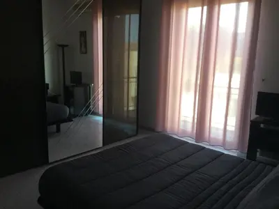 a bedroom with a bed and a large window at Elegante Appartamento Palermo in Palermo