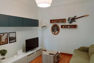 a kitchen with a stove and a table with chairs at Croce Barocca Apartment in Palermo