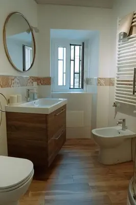 a bathroom with a sink and a mirror at Croce Barocca Apartment in Palermo