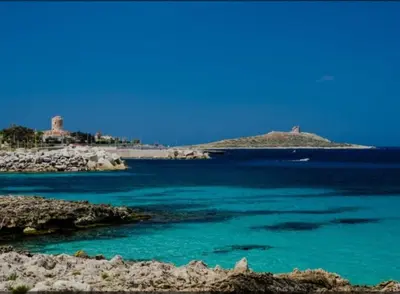 a body of water with a island in the background at Pietra Marina in Capaci
