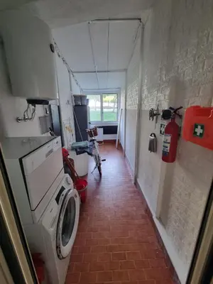 a laundry room with a washing machine in a room at Pietra Marina in Capaci